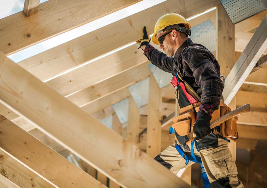 Construction worker in the rafters of a building